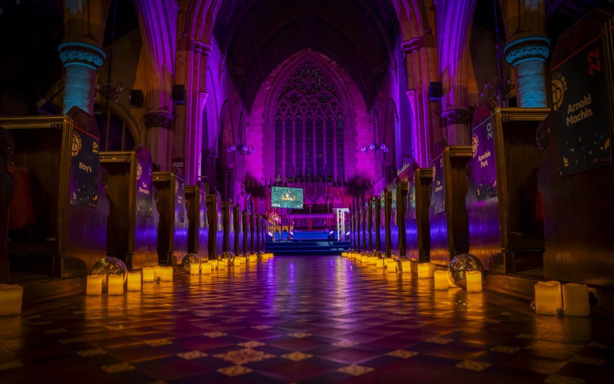 St Giles church lit in magenta and amber for the LoveNUL Awards