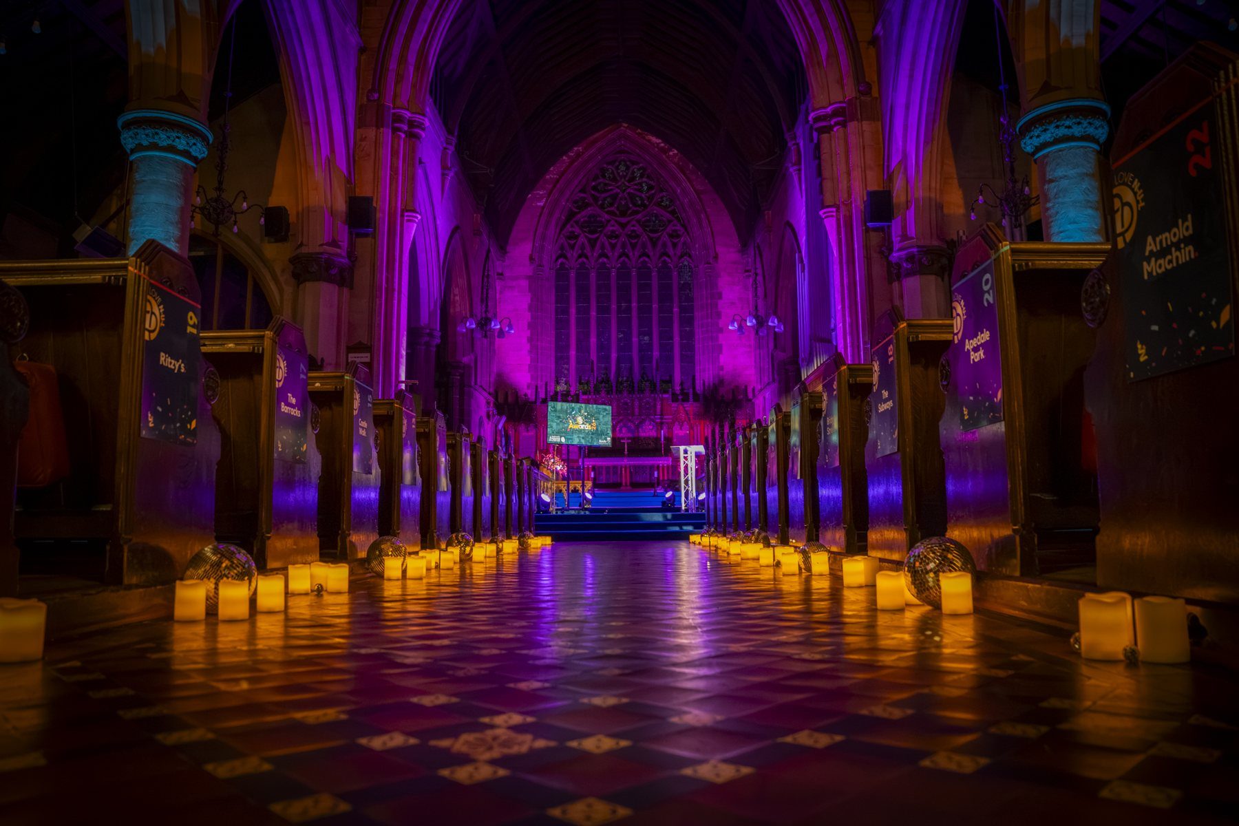St Giles church lit in magenta and amber for the LoveNUL Awards