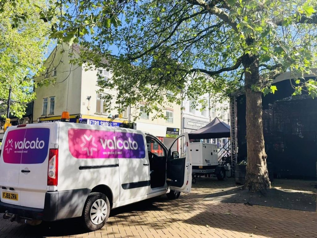 Branded Valcato van and generator during the festival build