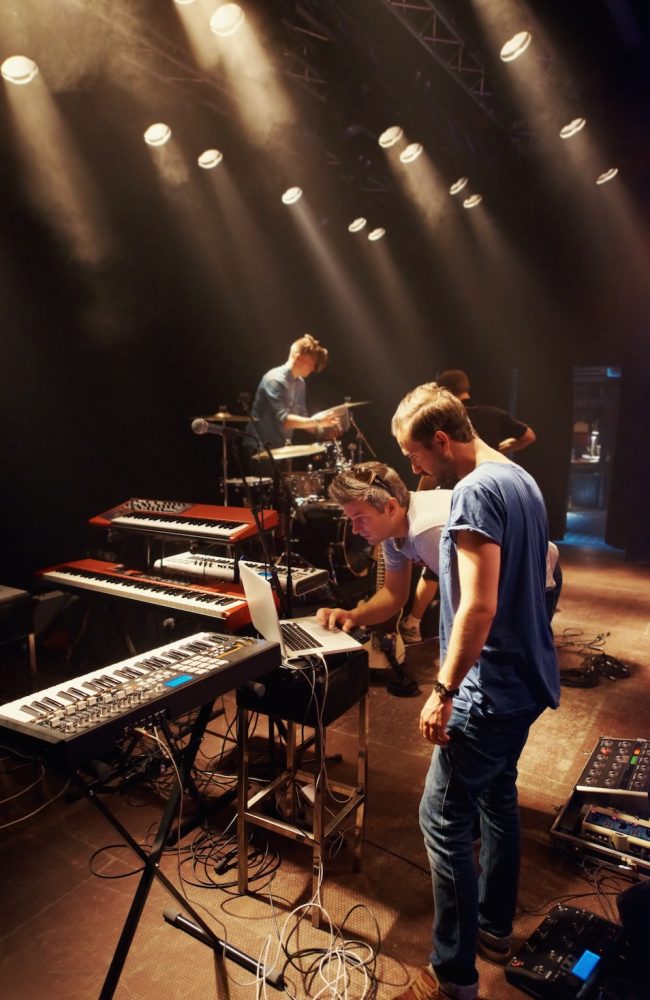 A keyboardist rocking out on stage